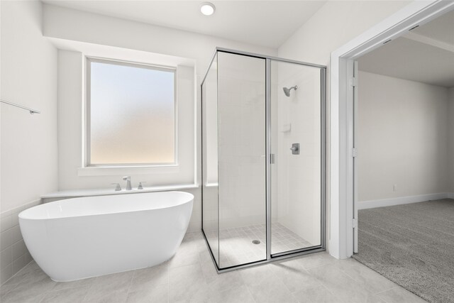 bathroom featuring tile patterned flooring and shower with separate bathtub