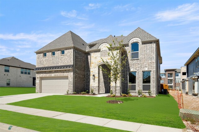 view of front of house featuring a garage and a front yard