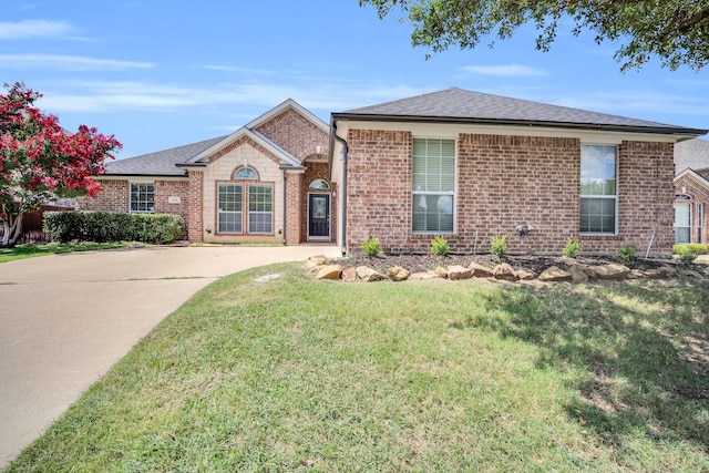 ranch-style home featuring a front yard