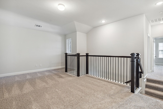 interior space featuring carpet and vaulted ceiling