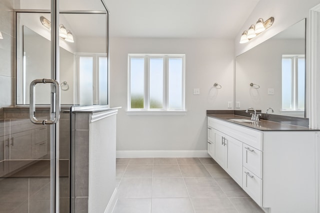 bathroom with tile patterned flooring, vanity, and a shower with door