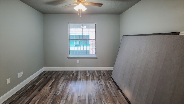 unfurnished room with dark hardwood / wood-style floors, ceiling fan, and a textured ceiling