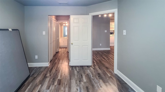 corridor featuring dark hardwood / wood-style floors