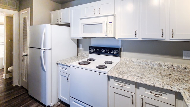 kitchen featuring white cabinetry, white appliances, dark hardwood / wood-style floors, and light stone countertops