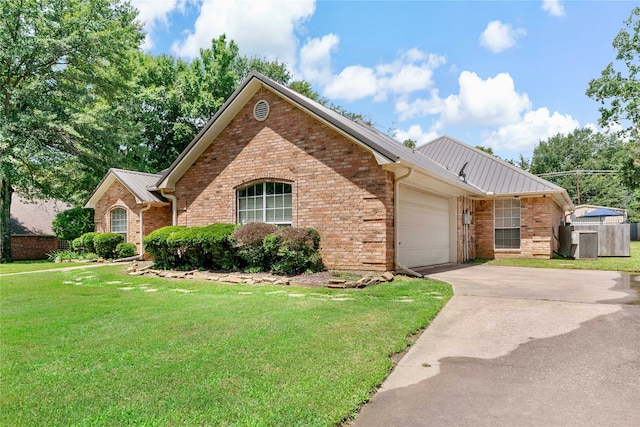 view of front of property with a garage and a front yard