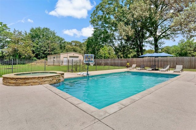 view of pool featuring a patio and an in ground hot tub