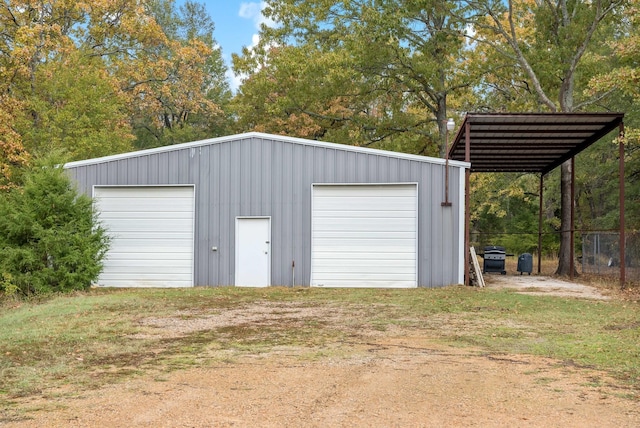 garage featuring a lawn and a carport