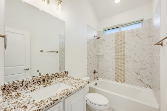 full bathroom featuring vanity, lofted ceiling, tiled shower / bath combo, and toilet