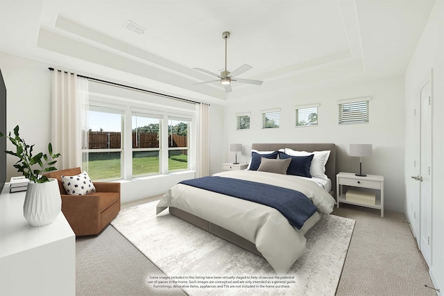 bedroom featuring ceiling fan, a raised ceiling, and carpet flooring