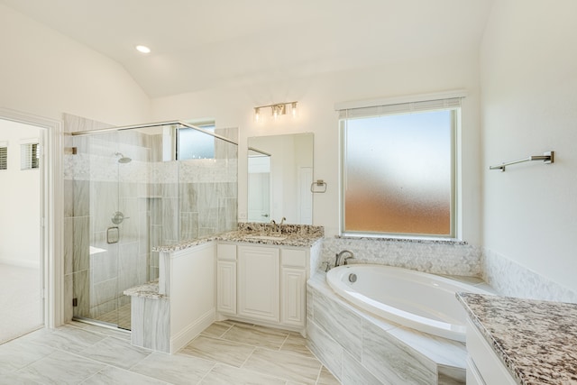 bathroom with vanity, separate shower and tub, lofted ceiling, and plenty of natural light