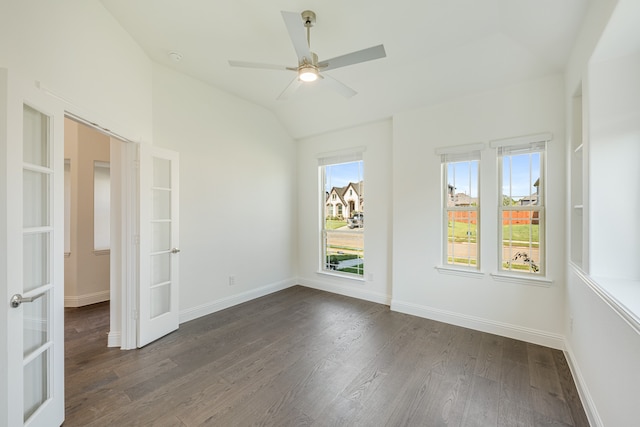 empty room with dark wood-type flooring, vaulted ceiling, and ceiling fan