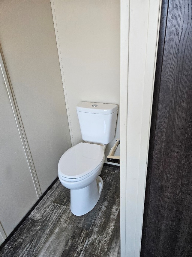 bathroom with toilet and wood finished floors