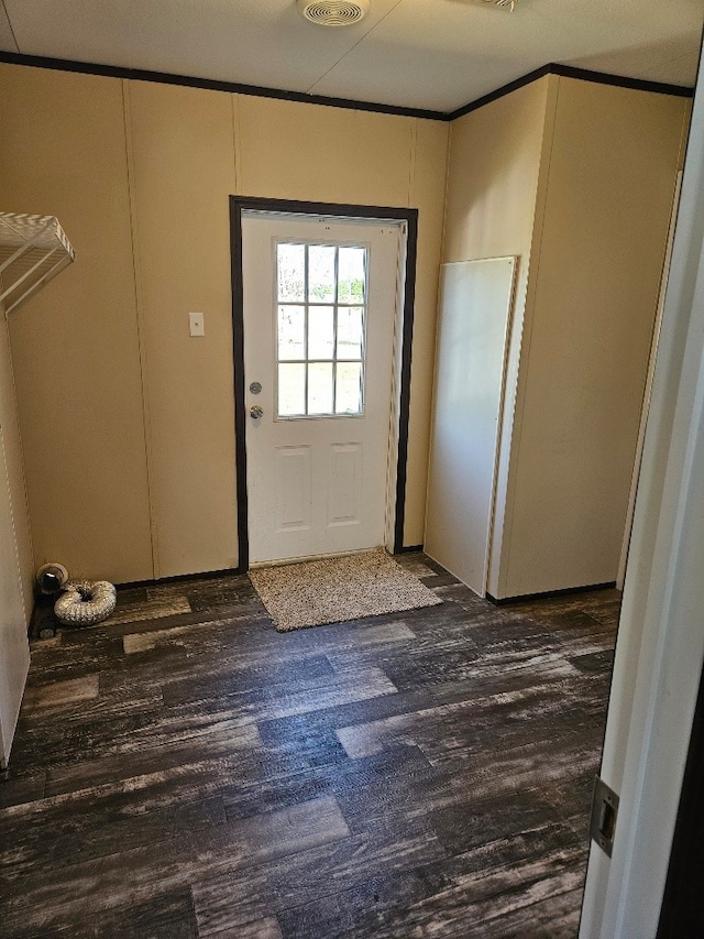entryway featuring wood finished floors and crown molding