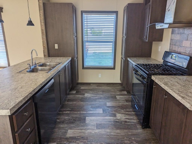 kitchen with dark wood-type flooring, hanging light fixtures, backsplash, sink, and black appliances