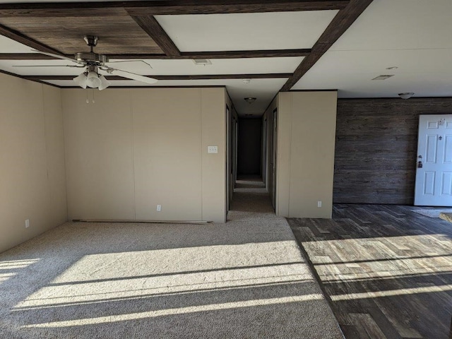 unfurnished room with ceiling fan and wood walls