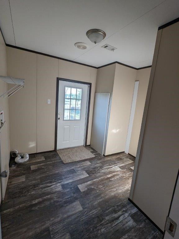 doorway featuring wood finished floors and visible vents