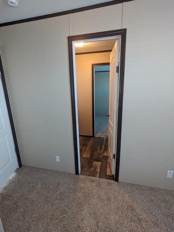 unfurnished bedroom with wood finished floors and carpet floors