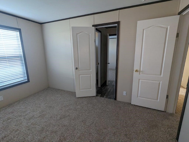 unfurnished bedroom featuring a closet and dark colored carpet