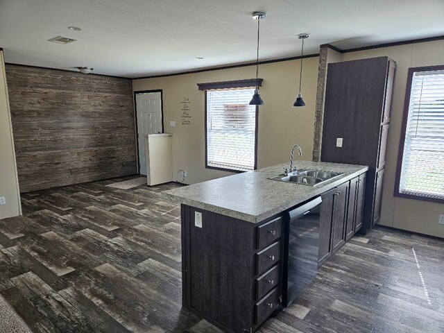 kitchen with kitchen peninsula, dark hardwood / wood-style floors, sink, and hanging light fixtures