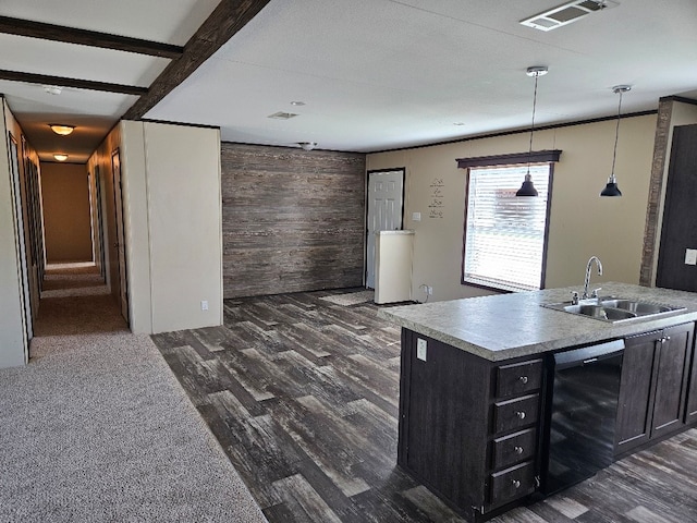 kitchen with black dishwasher, dark hardwood / wood-style floors, sink, wooden walls, and decorative light fixtures