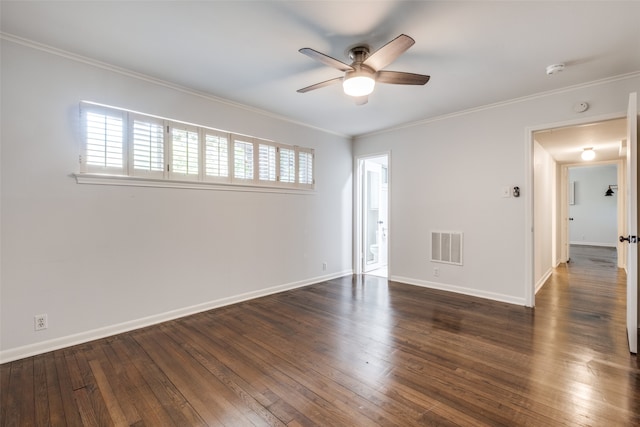 spare room with ceiling fan, crown molding, and dark wood-type flooring