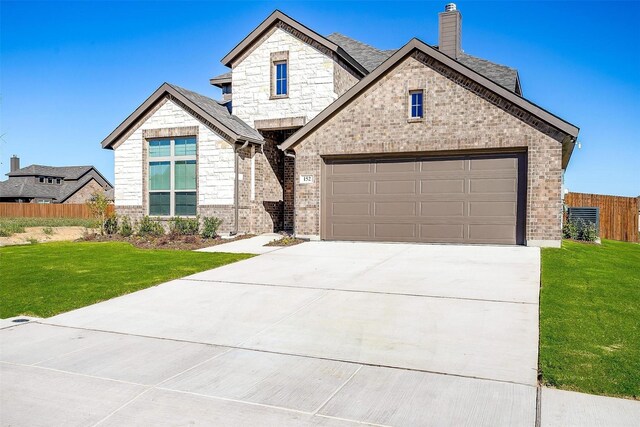 view of front facade featuring a garage and a front yard