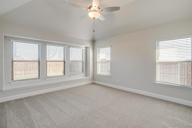 carpeted empty room featuring ceiling fan and lofted ceiling