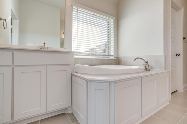 bathroom with tile patterned floors, a bathtub, and vanity