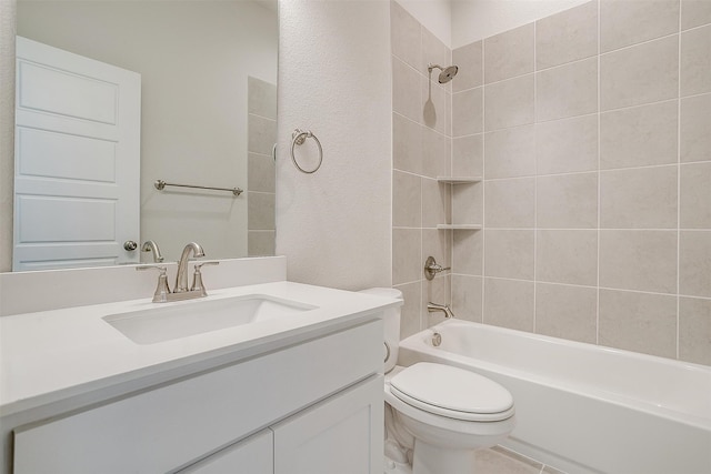 full bathroom featuring vanity, tiled shower / bath combo, and toilet