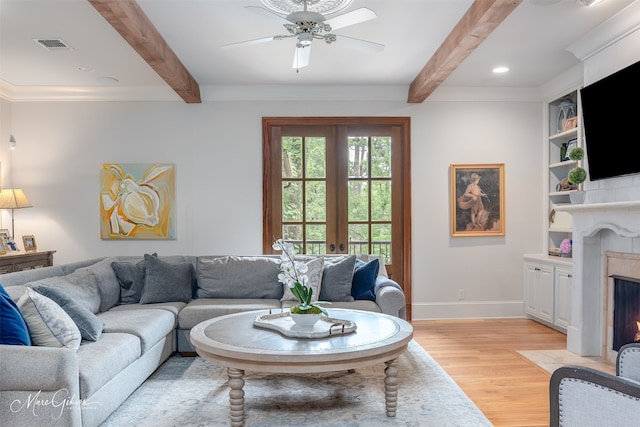 living room with ceiling fan, light hardwood / wood-style flooring, beamed ceiling, and french doors