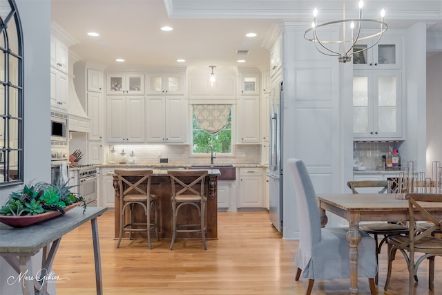 kitchen with a breakfast bar area, white cabinetry, and a center island