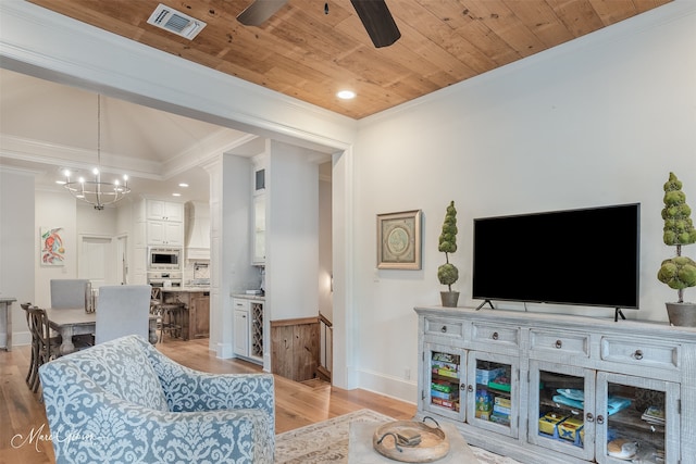 living room with light wood-type flooring, crown molding, and wood ceiling