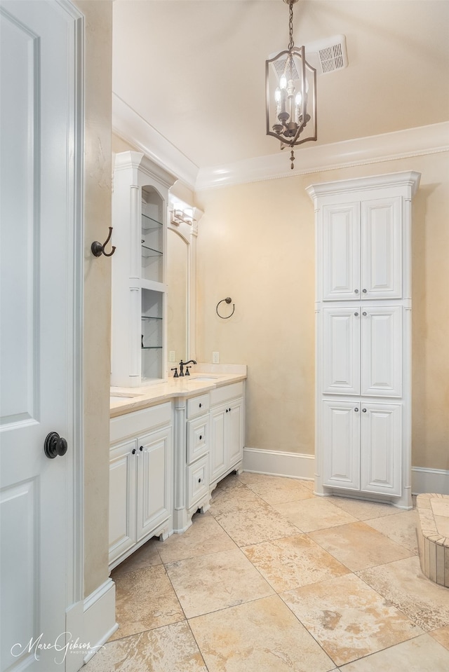 bathroom featuring crown molding, vanity, and a notable chandelier