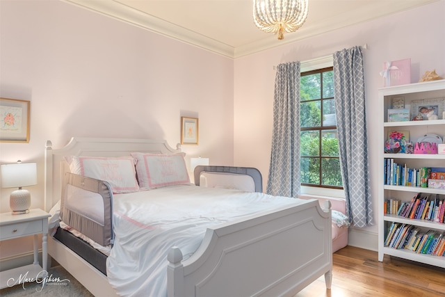 bedroom featuring ornamental molding and light hardwood / wood-style flooring