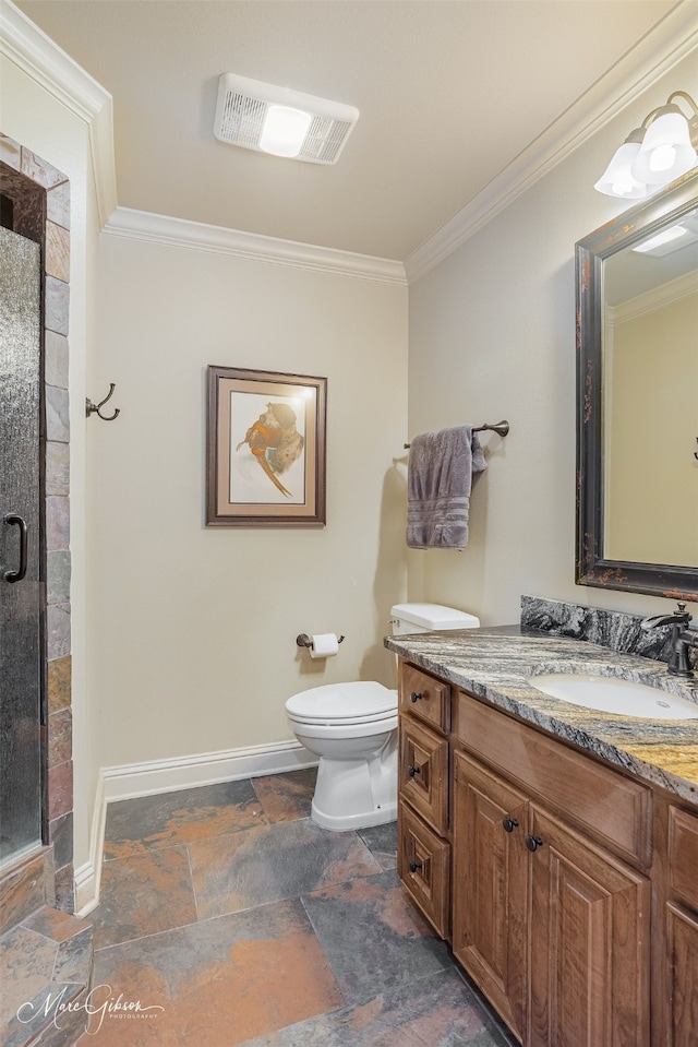 bathroom with vanity, toilet, a shower with door, and ornamental molding