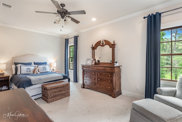 bedroom featuring multiple windows, ceiling fan, and ornamental molding