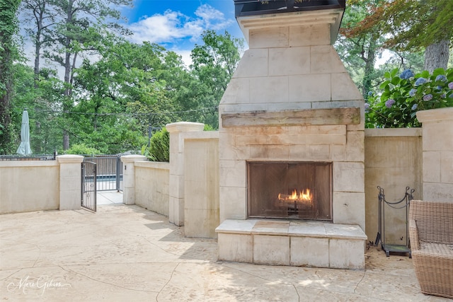 view of patio with an outdoor fireplace