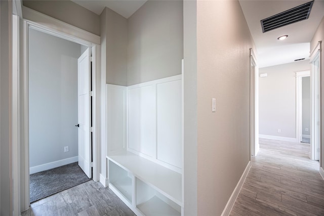 hallway with light hardwood / wood-style floors