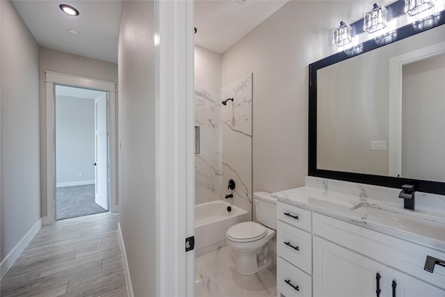 full bathroom featuring hardwood / wood-style floors, vanity, shower / bath combination, and toilet