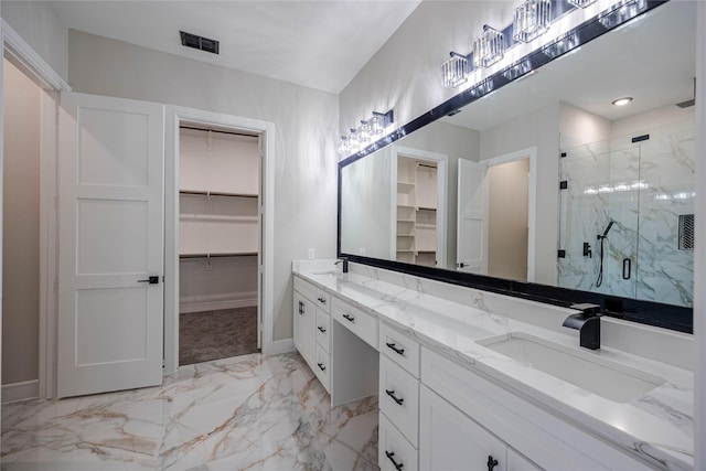 bathroom with vanity and a shower with door