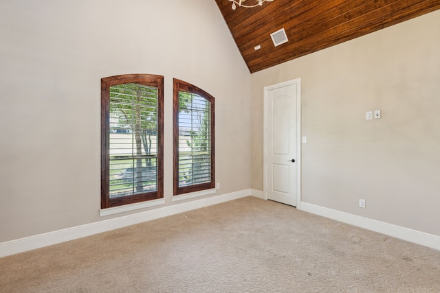 carpeted spare room with wood ceiling and high vaulted ceiling