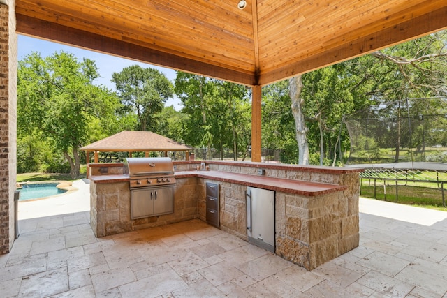 view of patio featuring a grill, area for grilling, and a gazebo