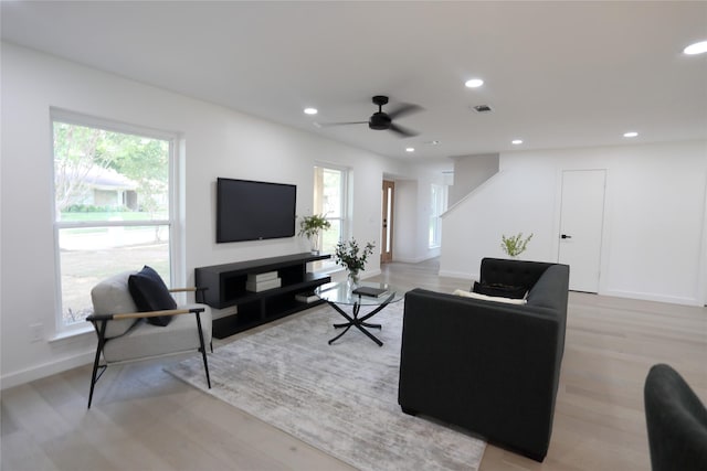 living room with ceiling fan and light hardwood / wood-style floors