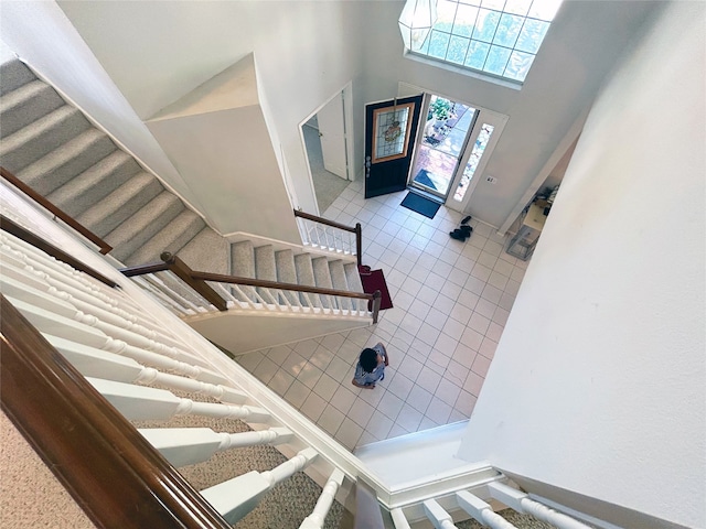 foyer with a high ceiling and tile patterned flooring