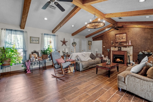 living room with dark hardwood / wood-style floors, a healthy amount of sunlight, vaulted ceiling with beams, and ceiling fan