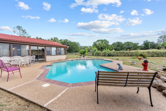 view of swimming pool with a patio area