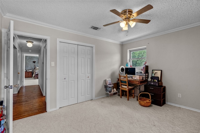 office area featuring ceiling fan, crown molding, carpet floors, and a textured ceiling