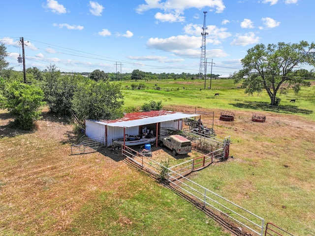 view of yard with an outdoor structure and a rural view