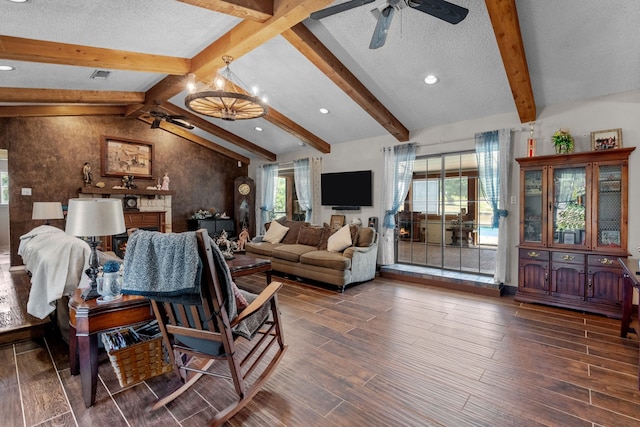 living room featuring vaulted ceiling with beams, ceiling fan, wood-type flooring, and a healthy amount of sunlight