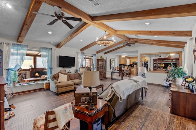 living room with a textured ceiling, ceiling fan with notable chandelier, lofted ceiling with beams, and hardwood / wood-style floors